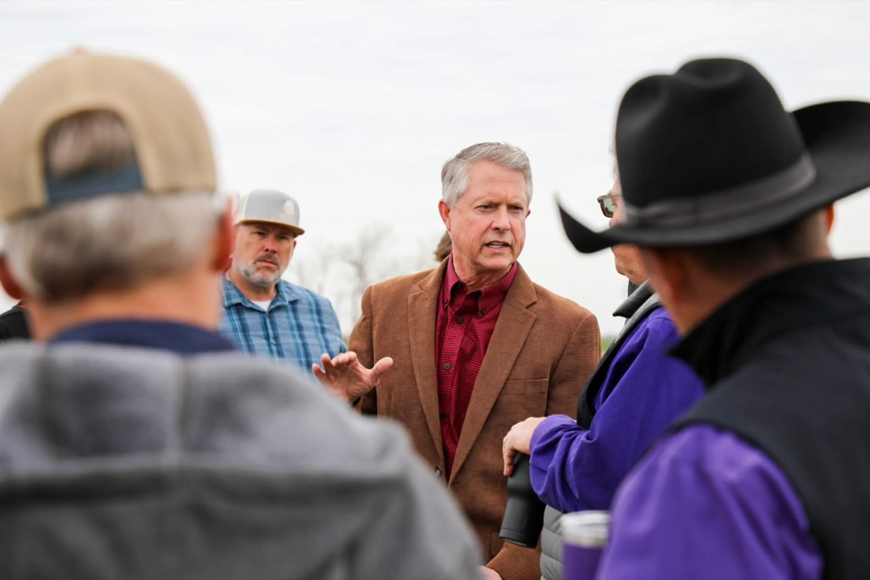 Sen. Roger Marshall talking with Kansas ranchers and farmers in the field.