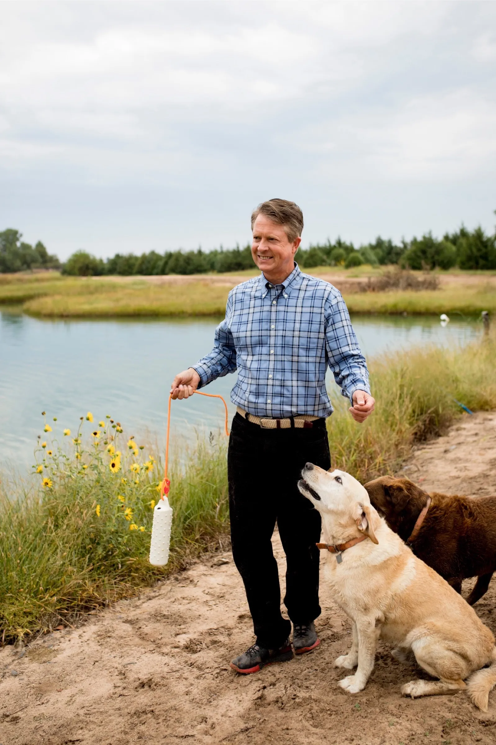 Roger Marshall at the family pond outside Great Bend with the dogs.